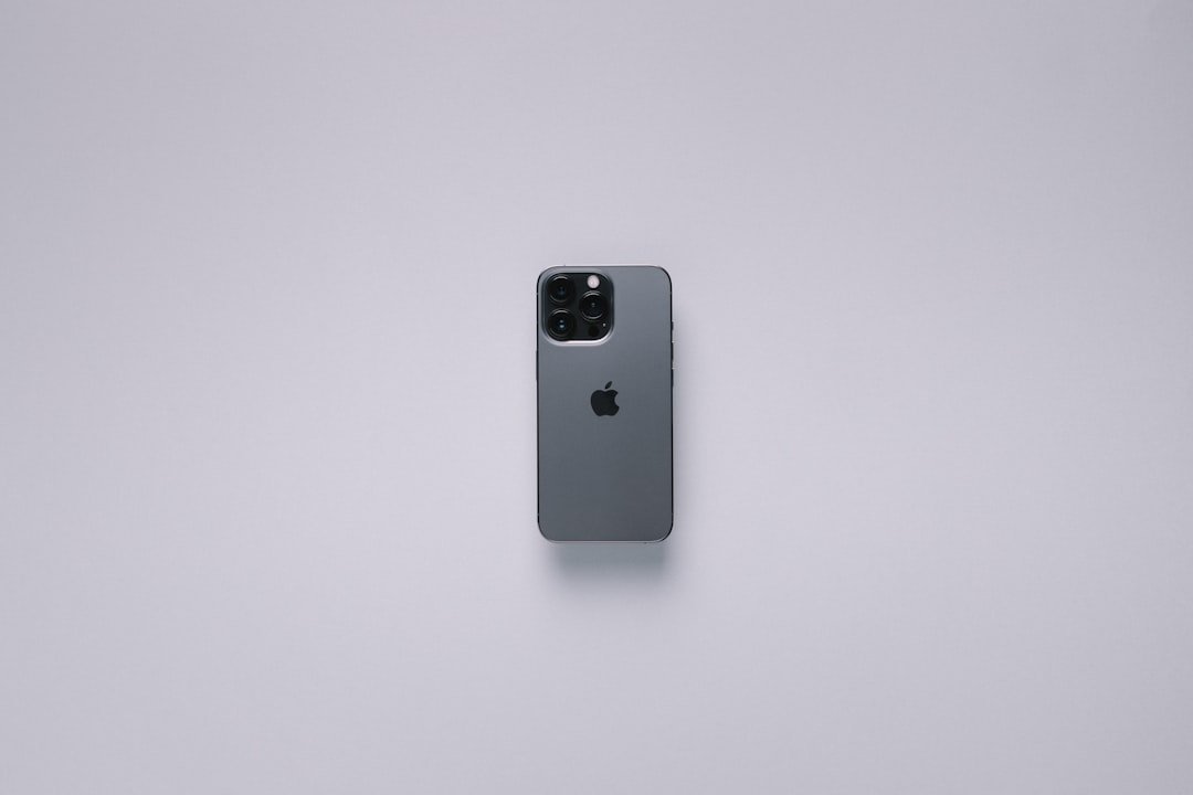 the back of an apple phone on a white surface