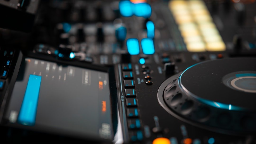 A close up of a dj's turntable and controller
