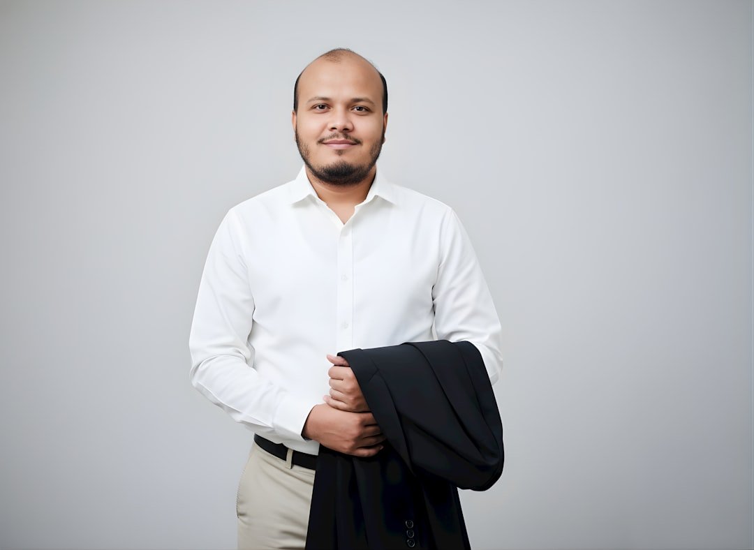 Man in white shirt holding a suit jacket