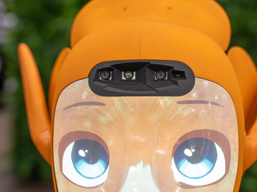 Close-up of an orange robot's face with blue eyes