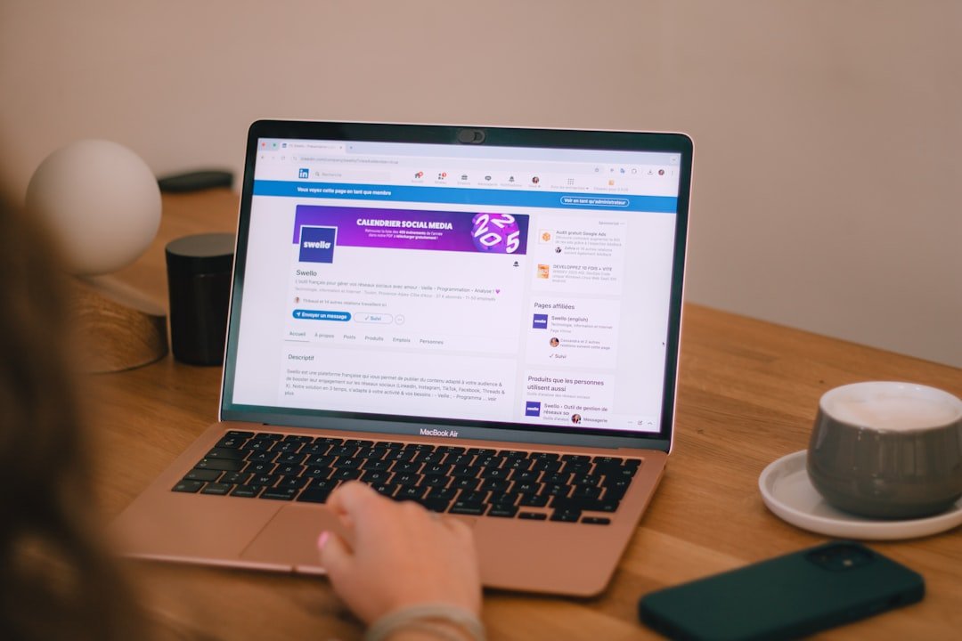 Someone is using a laptop, likely browsing social media.